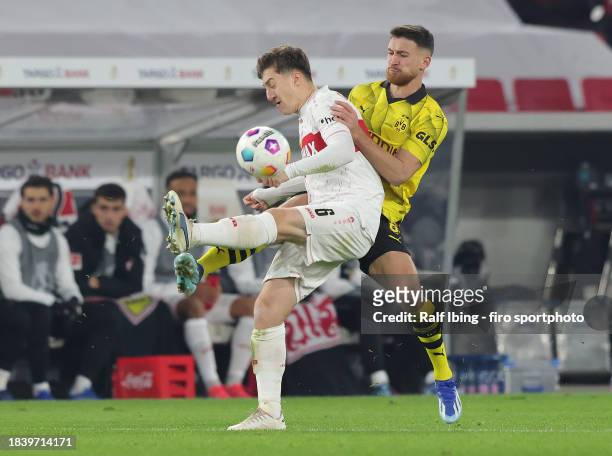 Angelo Stiller of VfB Stuttgart and Salih Özcan of Borussia Dortmund compete for the ball during the DFB cup round of 16 match between VfB Stuttgart...
