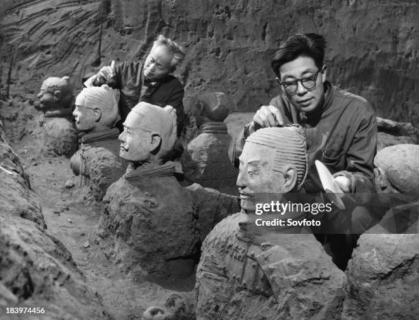 Archaeologists excavating terra-cotta warriors and horses at the tomb of the first emperor of China, Qin Shi Huang, in Xi'an, Shaanxi province,...