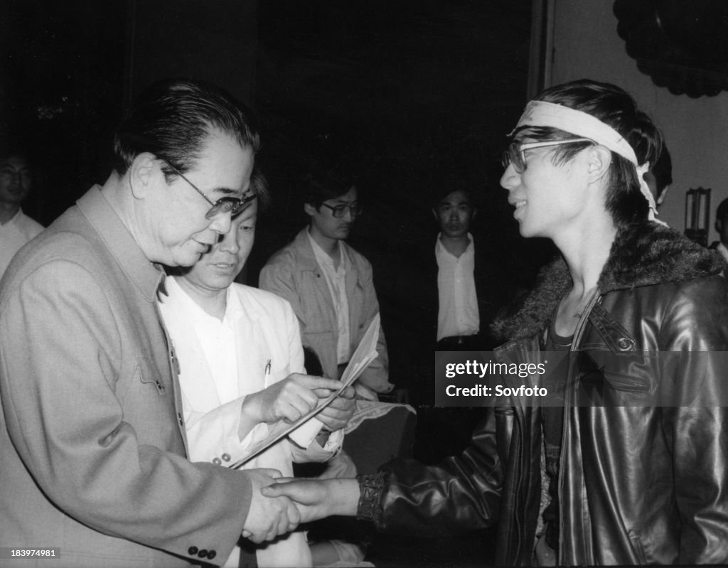 Chinese premier Li Peng (left) shakes hands with Wang Dan, representative of Beijing University pro-democracy hunger strikers. May 1989. Beijing, China.