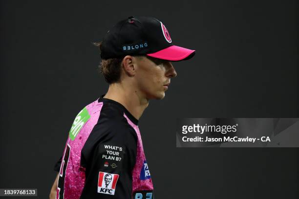 Tom Curran of the Sixers looks on during the BBL match between Sydney Sixers and Melbourne Renegades at Sydney Cricket Ground on December 08, 2023 in...