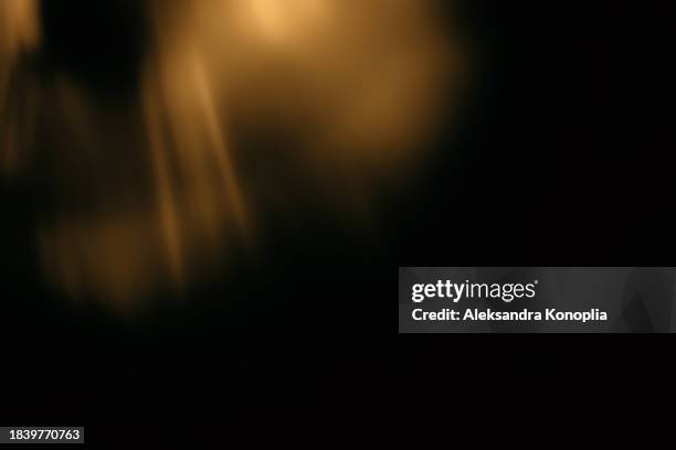 golden crystal rainbow light leak texture effect on black background - effetto luminoso foto e immagini stock