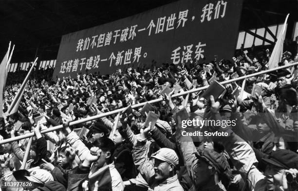 Holding high the red covered 'Quotations from Chairman Mao Tse-tung', young revolutionary fighters of the Red Guards Congress of Peking middle...