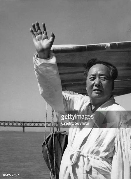 Chairman Mao standing on the deck of a motorboat reviewing swimmers on the Yangtze River. July 26, 1966.