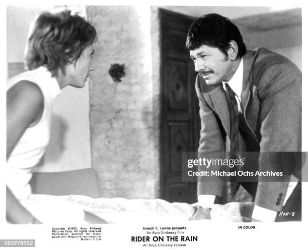 Actress Marlene Jobert and actor Charles Bronson on set of the Embassy Pictures movie "Rider on the Rain" in 1970.
