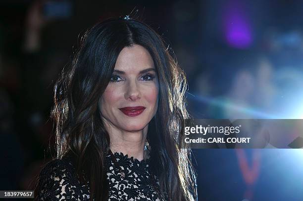 Actress Sandra Bullock poses for pictures on the red carpet as he arrives for the screeing of her latest film "Gravity", directed by Mexican Alfonso...