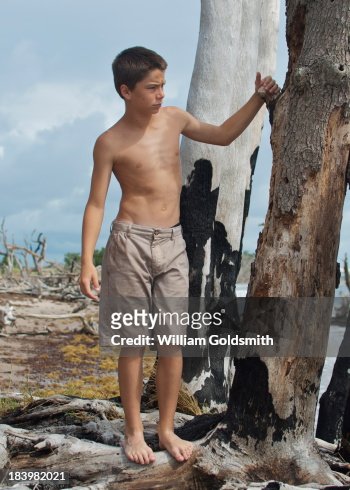 Boy Exploring Island On Deserted Beach High-Res Stock Photo - Getty Images
