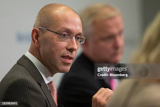 Joerg Asmussen, executive board member of the European Central Bank , left, speaks during a panel discussion with Olli Rehn, economic and monetary...