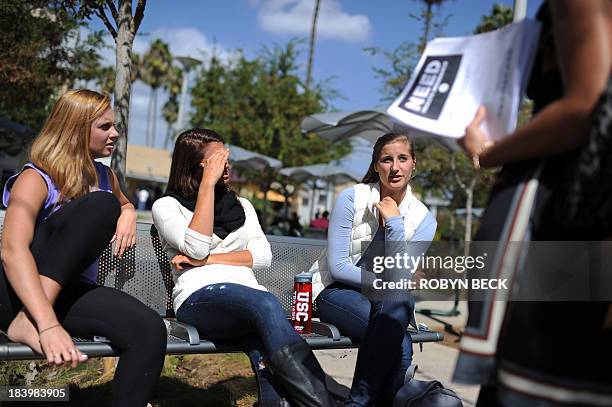 Students Amanda McComas , Rose Marie Chute and Sari Schwartz have a discussion about Obamacare with Lisa Fiori , a supporter of the Affordable...