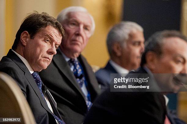 Colm Kelleher, president of institutional securities for Morgan Stanley, left, and David Walker, chairman of Barclays Plc, second left, listen during...