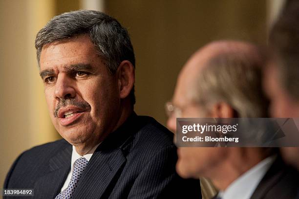 Mohamed El-Erian, chief executive officer and co-chief investment officer of Pacific Investment Management Company LLC , left, speaks during the 2013...