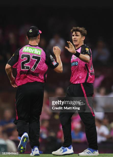 Sean Abbott of the Sixers celebrates with team mates after taking the wicket of Aaron Finch of the Renegades during the BBL match between Sydney...