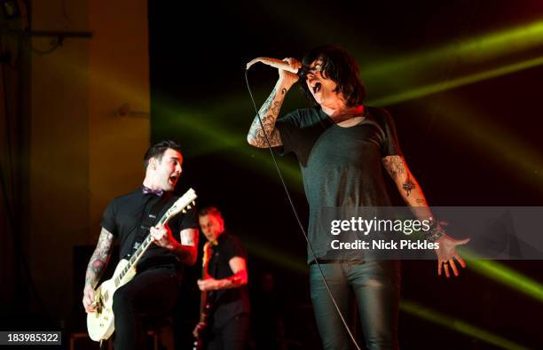 Jack Fowler and Kellin Quinn of Sleeping With Sirens perform on stage at Brixton Academy on October 10, 2013 in London, England.