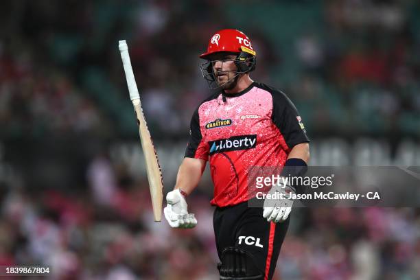 Aaron Finch of the Renegades walks off the field after been dismissed by Sean Abbott of the Sixers during the BBL match between Sydney Sixers and...