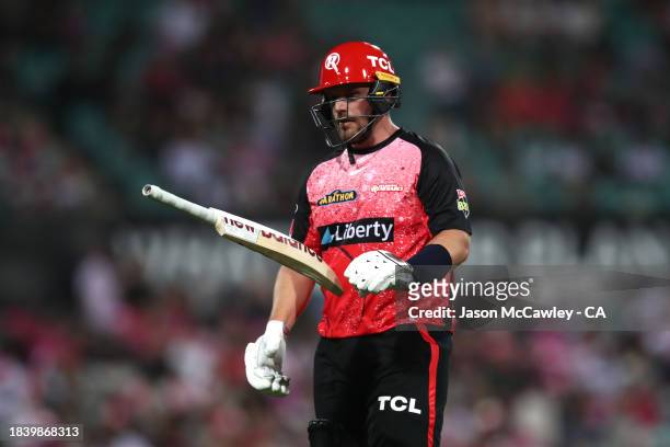 Aaron Finch of the Renegades walks off the field after been dismissed by Sean Abbott of the Sixers during the BBL match between Sydney Sixers and...