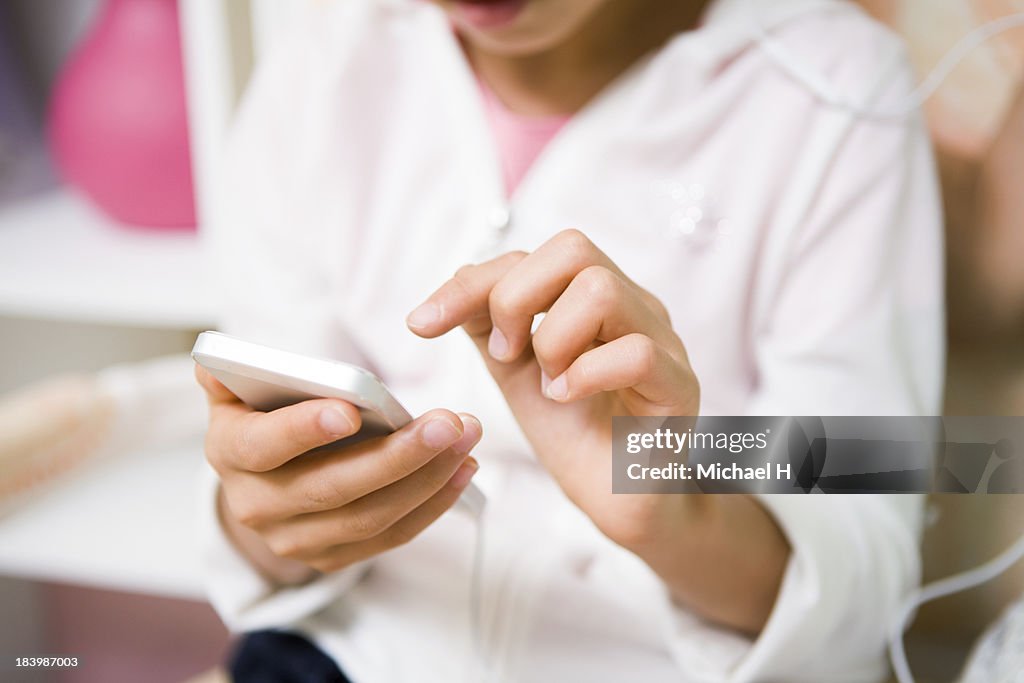 A girl is listening music by Smartphone