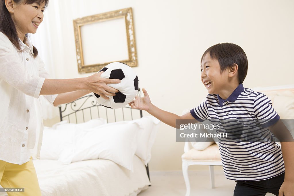 A boy with stuffed toy in his room