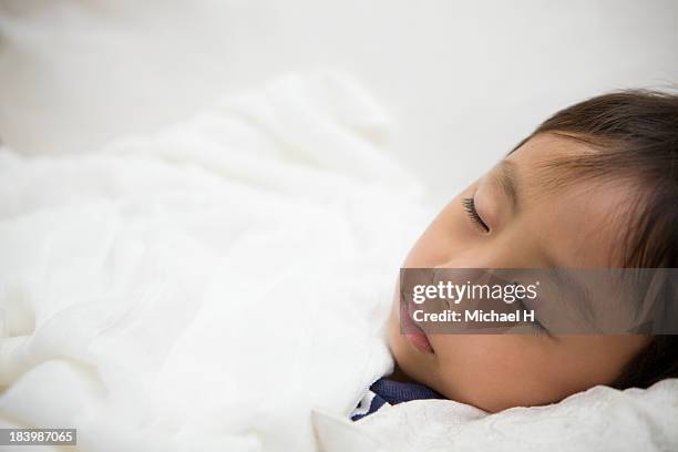 a young boy is sleeping in the bed - bed on white background stock pictures, royalty-free photos & images