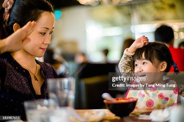 mom & toddler girl making the salute gesture - child saluting stock pictures, royalty-free photos & images