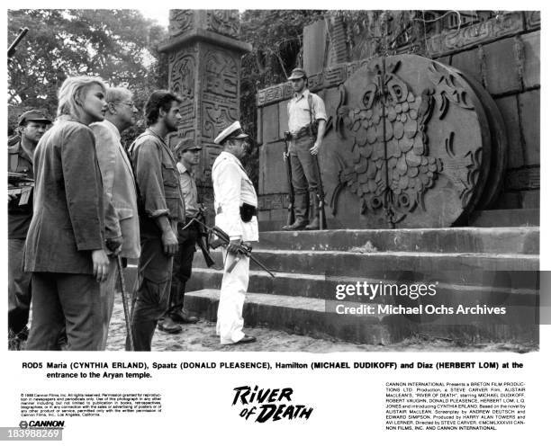 Actress Cynthia Erland, actors Donald Pleasence, Michael Dudikoff and Herbert Lom on set of the Cannon Films movie "River of Death" in 1989.