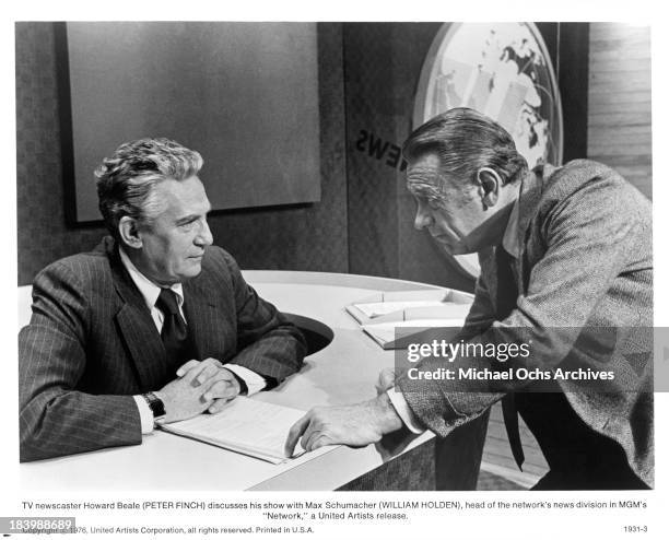 Actor Peter Finch and William Holden on set of the MGM movie "Network" in 1976.