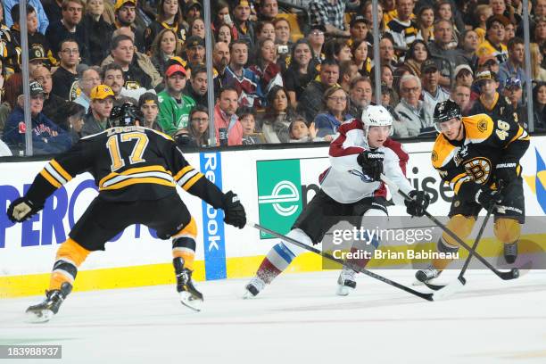Matt Duchene of the Colorado Avalanche skates against Milan Lucic and David Krejci of the Boston Bruins at the TD Garden on October 10, 2013 in...