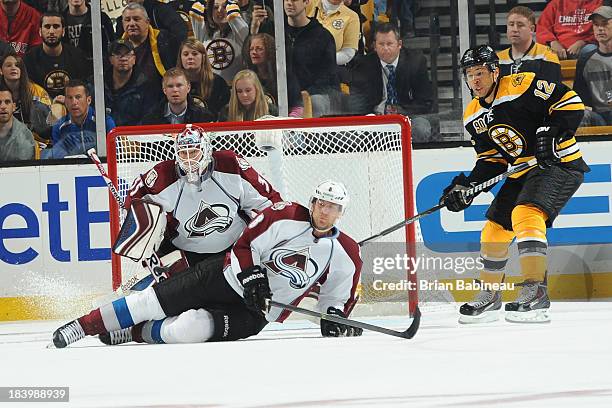 Jan Hejda and Jean-Sebastian Giguere of the Colorado Avalanche try to block the shot against the Boston Bruins at the TD Garden on October 10, 2013...