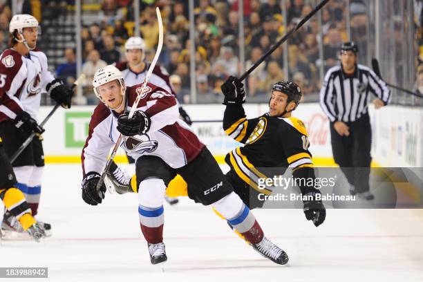 Gabriel Landeskog of the Colorado Avalanche skates against Gregory Campbell of the Boston Bruins at the TD Garden on October 10, 2013 in Boston,...