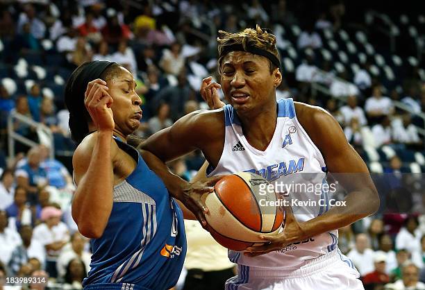 Maya Moore of the Minnesota Lynx draws a charge from Angel McCoughtry of the Atlanta Dream during Game Three of the 2013 WNBA Finals at Philips Arena...