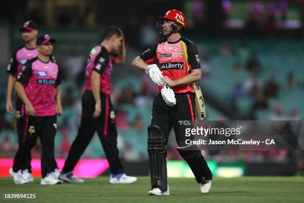 Tom Rogers of the Renegades walks off the field after been dismissed by Ben Dwarshuis of the Sixers during the BBL match between Sydney Sixers and...