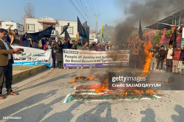 Pasban-e-Hurriyat Jammu and Kashmir activists shout slogans at Muzaffarabad in Pakistan, on December 11 as they protest against India's Supreme Court...