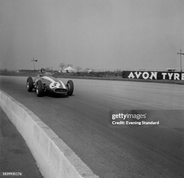 American racing driver Masten Gregory in his Maserati 250F car during the BRDC International Trophy Race, Silverstone circuit, Northamptonshire, May...