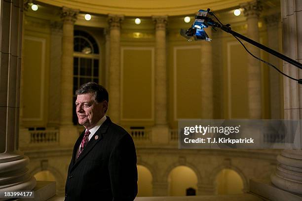 Representative Tom Cole waits to appear in a live CNN interview as congressional staff continue negotiations in to the night at the U.S. Capitol on...