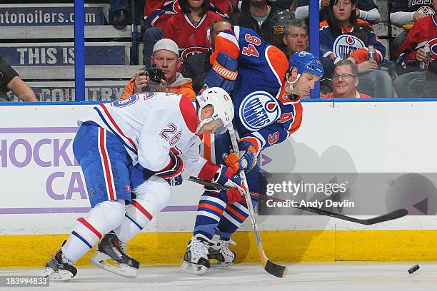 Ryan Smyth of the Edmonton Oilers battles for the puck against Josh Gorges of the Montreal Canadiens on October 10, 2013 at Rexall Place in Edmonton,...