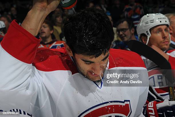 Max Pacioretty of the Montreal Canadiens cools off with water during a game against the Edmonton Oilers on October 10, 2013 at Rexall Place in...