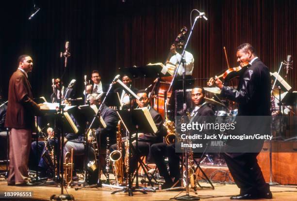 American Jazz musician and composer Wynton Marsalis conducts the Lincoln Center Jazz Orchestra, with violinist Michael Ward, in the world premiere of...