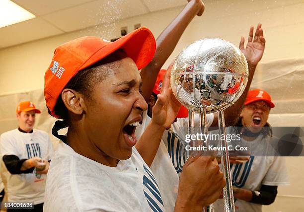 Maya Moore of the Minnesota Lynx celebrates with the trophy after their 86-77 win over the Atlanta Dream in Game Three of the 2013 WNBA Finals at...