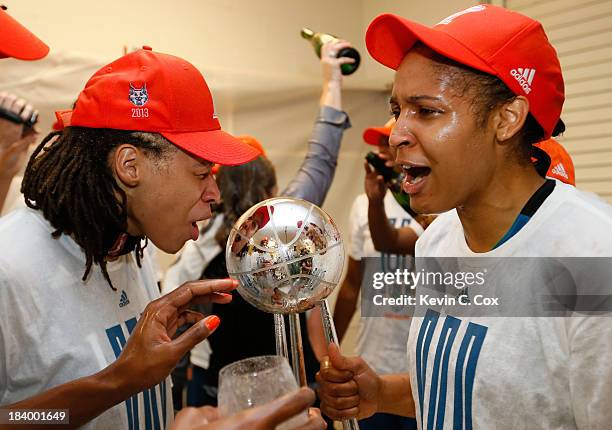 Seimone Augustus and Maya Moore of the Minnesota Lynx celebrate with the trophy after their 86-77 win over the Atlanta Dream in Game Three of the...