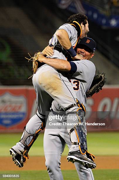 Joaquin Benoit of the Detroit Tigers celebrates their 3 to 0 win over the Oakland Athletics with Alex Avila in Game Five of the American League...