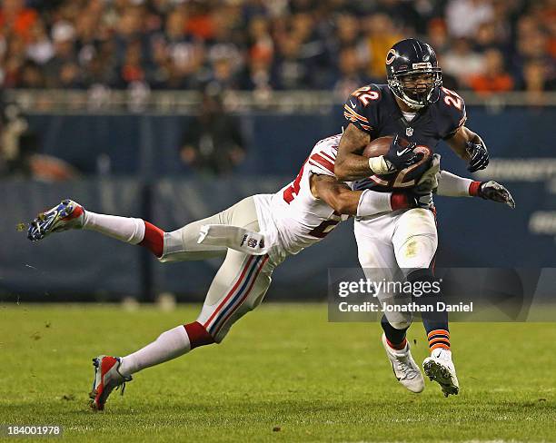 Matt Forte of the Chicago Bears breaks away from Terrell Thomas of the New York Giants at Soldier Field on October 10, 2013 in Chicago, Illinois. The...