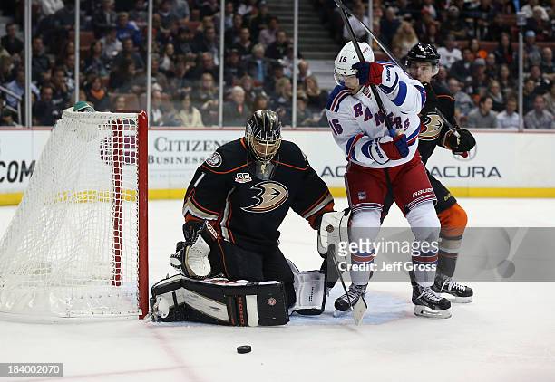 Goaltender Jonas Hiller of the Anaheim Ducks makes a save, as Derick Brassard of the New York Rangers and Ben Lovejoy of the Ducks pursue the play in...