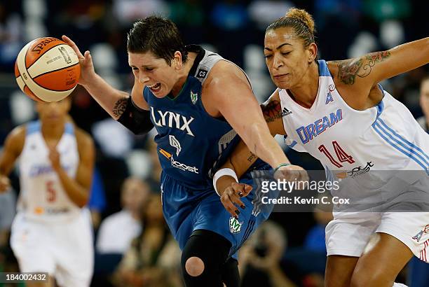 Janel McCarville of the Minnesota Lynx steals the ball from Erika de Souza of the Atlanta Dream during Game Three of the 2013 WNBA Finals at Philips...