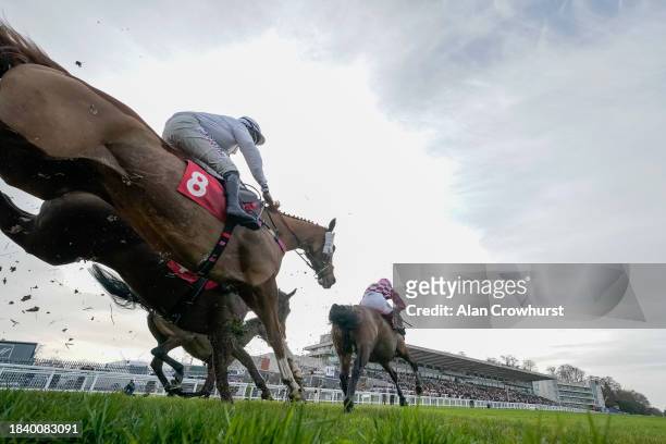General view as runners clear the fence in front of the grandstands at Sandown Park Racecourse on December 08, 2023 in Esher, England.