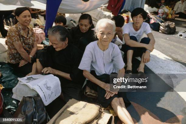 Vietnamese refugees sheltering under a makeshift canopy aboard the freighter 'Tung An' in Manila Bay, Philippines, February 13th 1979.