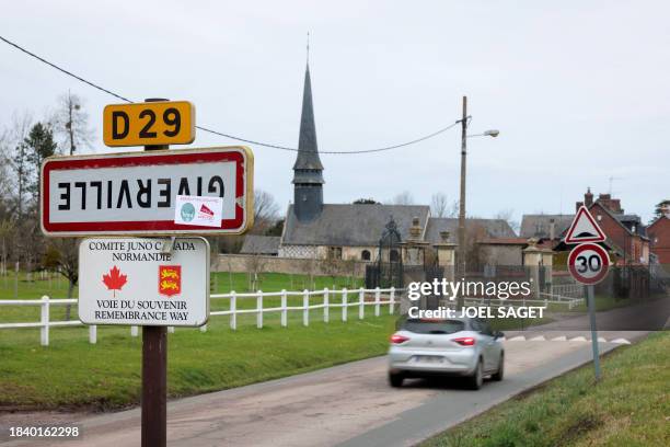 Photograph taken on December 7 shows a road sign indicating the entrance of the French town of Giverville, north-western France, which has been...