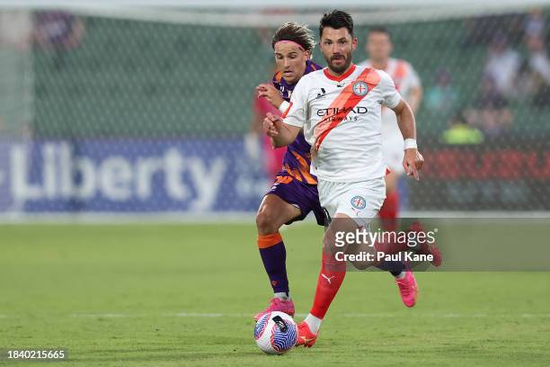 Tolgay Arslan of Melbourne City controls the ball against Giordano Colli of the Glory during the A-League Men round seven match between Perth Glory...