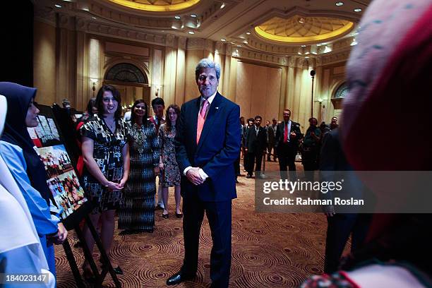 Secretary of State, John Kerry interacts with Fullbright School participants during the Global Entrepreneurship Summit on October 11, 2013 in Kuala...