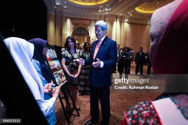 Secretary of State, John Kerry interacts with Fullbright School participants during the Global Entrepreneurship Summit on October 11, 2013 in Kuala...