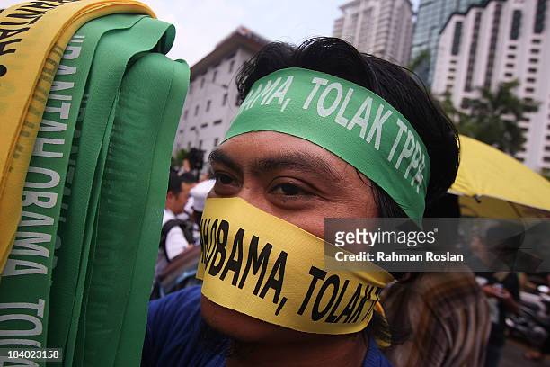 Protester wears a bandana that reads "Reject Obama" during a protest against Trans Pacific Partnership Agreement outside the Global Entrepreneurship...