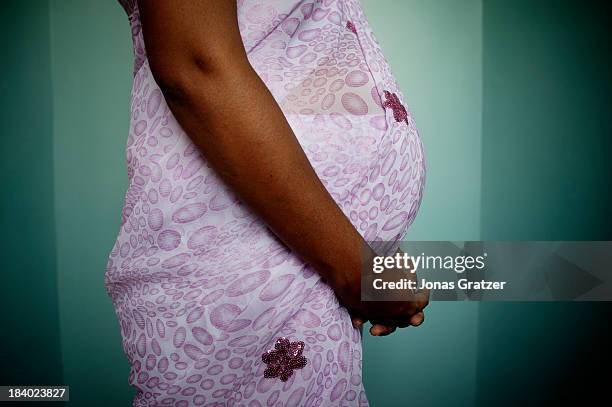 The belly of a pregnant surrogate mother from Mumbai. Eggs from Europeans, semen from wealthy Westerners and embryos planted in desperate women's...