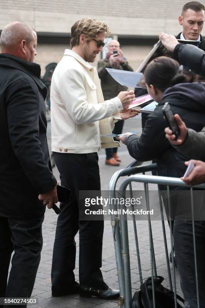 Ryan Gosling signing autographs for fans as he arrives at BFI Southbank for an 'In Conversation about Barbie' event on December 08, 2023 in London,...